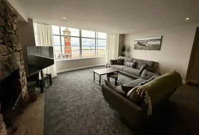 a living room with couches and a flat screen tv at Clock Tower Apartments 1 in Morecambe