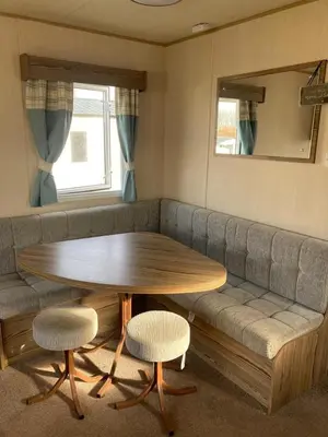 a living room with a table and a couch at A fully equiped caravan Marton mere haven in Blackpool