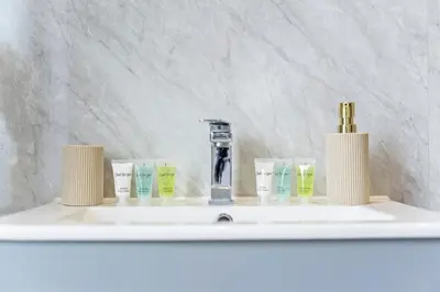 a bathroom counter with a sink with toothbrushes at Stylish House - Sleeps 7 - Free Parking, Fast WiFi and Smart TV - Contractors, Groups and Long Stays Welcome by Yoko Property in Wigan