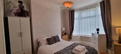 a small bedroom with a bed and a window at A nice home in Liverpool in Liverpool