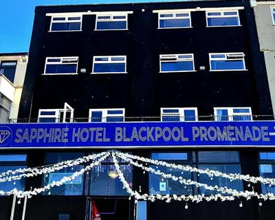 a building with a blue and white sign on it at Sapphire hotel blackpool promenade in Blackpool