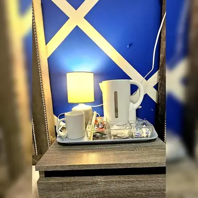 a tray with cups and a lamp on a table at Sapphire hotel blackpool promenade in Blackpool