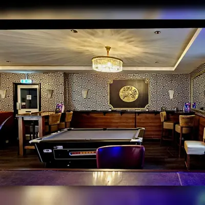 a ping pong table in a bar with a pool table at Sapphire hotel blackpool promenade in Blackpool