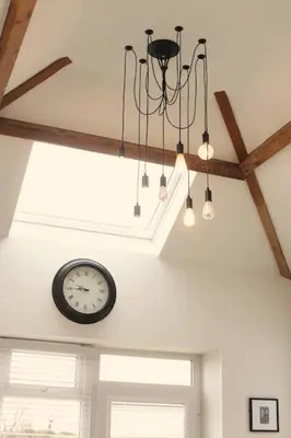 a clock on the ceiling of a room with lights at Stunning Coach House with two bedrooms and parking in Hambleton