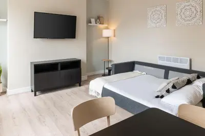 a bedroom with two beds and a flat screen tv at Host & Stay - The Quarter in Liverpool