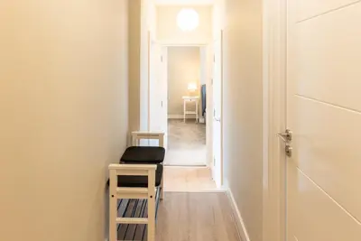 a hallway with a chair and a table and a door at Host & Stay - The Quarter in Liverpool