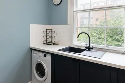 a kitchen with a sink and a washing machine at Host & Stay - The Quarter in Liverpool