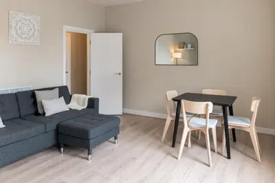 a living room with a couch and a table and chairs at Host & Stay - The Quarter in Liverpool