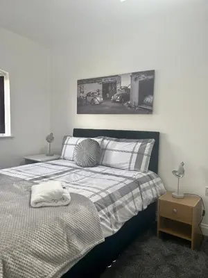 a bedroom with a bed and a picture on the wall at St Andrews house Hotel in Preston
