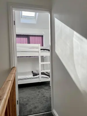 a small room with a bunk bed in a room at St Andrews house Hotel in Preston