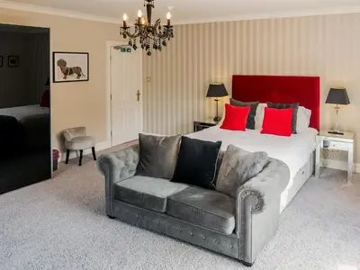 a bedroom with a large bed and a couch at The Farmhouse At Ream Hills in Weeton