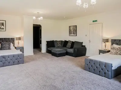 a living room with two beds and a couch at The Farmhouse At Ream Hills in Weeton