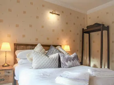 a bedroom with a large white bed with pillows at The Farmhouse At Ream Hills in Weeton
