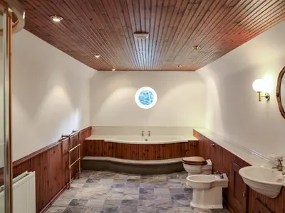 a bathroom with a tub and a toilet and a sink at The Farmhouse At Ream Hills in Weeton