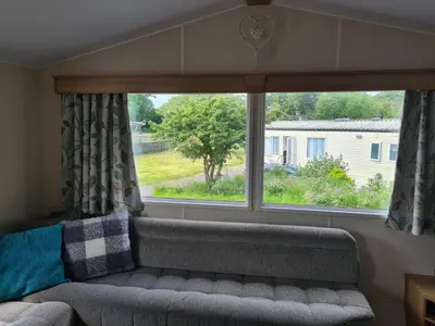 a couch in a room with a large window at The Mayflower in Millom