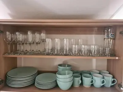 a cupboard filled with glasses and plates and bowls at The Mayflower in Millom