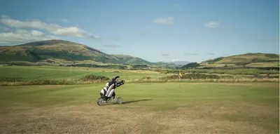a motorcycle is parked on a golf course at The Mayflower in Millom