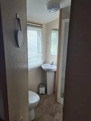 a bathroom with a toilet and a sink at The Mayflower in Millom