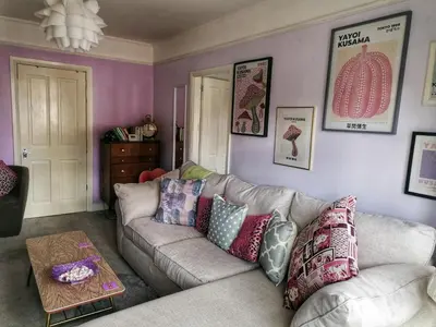 a living room with a couch with pillows on it at Aqua View, New Brighton Beach- 2 Bedroom with BALCONY & VIEW in New Brighton