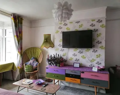 a living room with a tv on a wall at Aqua View, New Brighton Beach- 2 Bedroom with BALCONY & VIEW in New Brighton