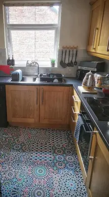 a kitchen with a sink and a stove and a window at Aqua View, New Brighton Beach- 2 Bedroom with BALCONY & VIEW in New Brighton