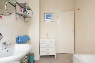a bathroom with a sink and a mirror at Comfy Home King Size Bed close to Asda & Sefton Park, Very Fast WIFI! in Liverpool