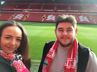a man and a woman standing in front of a stadium at Comfy Home King Size Bed close to Asda & Sefton Park, Very Fast WIFI! in Liverpool