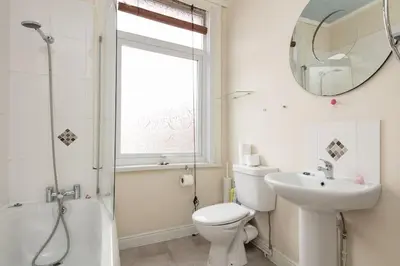 a bathroom with a toilet and a sink and a mirror at Comfy Home King Size Bed close to Asda & Sefton Park, Very Fast WIFI! in Liverpool