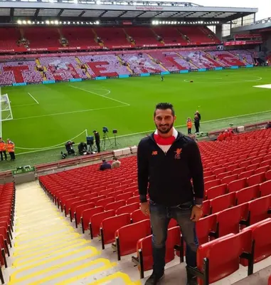 a man standing in front of a soccer stadium at Comfy Home King Size Bed close to Asda & Sefton Park, Very Fast WIFI! in Liverpool