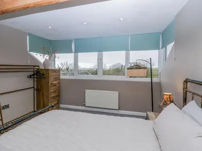 a bedroom with a bed and a window at Willow Cottage in Carnforth