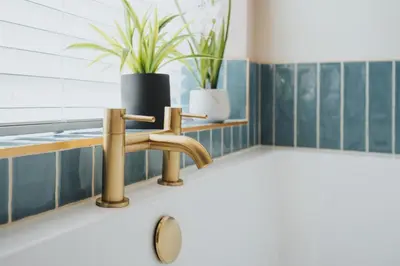 a chair in a bathroom with blue tiles at The Tides, 3 bed house Morecambe in Morecambe