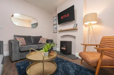 a living room with a couch and a fire place at The Tides, 3 bed house Morecambe in Morecambe