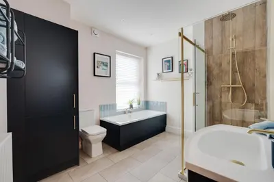 a bathroom with a tub and a toilet and a sink at The Tides, 3 bed house Morecambe in Morecambe