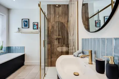 a bathroom with a shower and a tub and a sink at The Tides, 3 bed house Morecambe in Morecambe