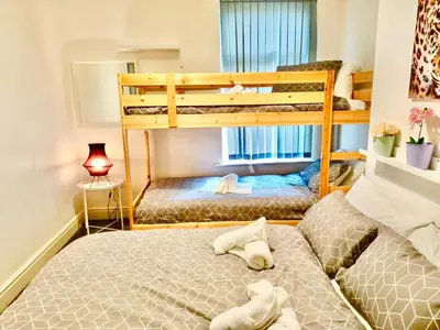 two beds in a room with two bunk beds at Liverpool 4 Bed Home Sleeps 18 Free Parking in Liverpool