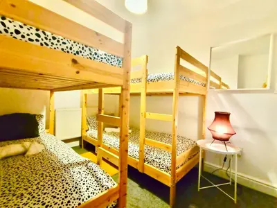 a bedroom with two bunk beds and a lamp at Liverpool 4 Bed Home Sleeps 18 Free Parking in Liverpool