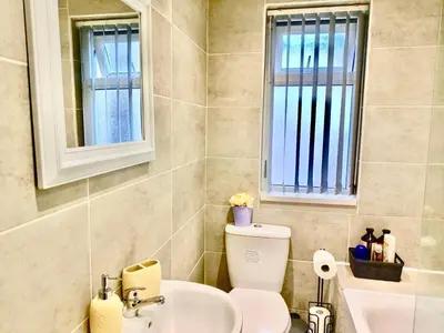 a bathroom with a toilet and a sink at Liverpool 4 Bed Home Sleeps 18 Free Parking in Liverpool