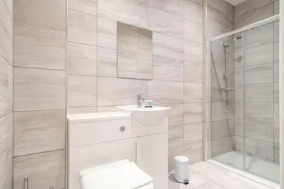 a bathroom with a toilet and a sink and a shower at Central Preston Modern 1 Bedroom Apartment in Preston