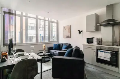 a living room with a couch and a table at Central Preston Modern 1 Bedroom Apartment in Preston