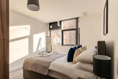 a bedroom with a large bed and a window at Fantastic 1 Bed Central Preston Apartment in Preston