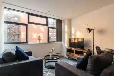 a living room with two couches and a television at Fantastic 1 Bed Central Preston Apartment in Preston
