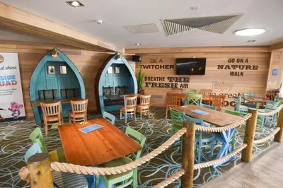 a dining room with a table and chairs in a restaurant at Elite Retreat Blackpool in Blackpool