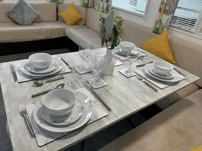 a table with plates and wine glasses on it at Elite Retreat Blackpool in Blackpool