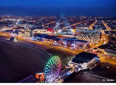 a city skyline with a ferris wheel at night at Elite Retreat Blackpool in Blackpool