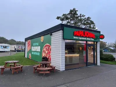 two picnic tables in front of a pizza shop at Elite Retreat Blackpool in Blackpool