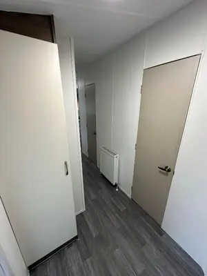 an empty room with two doors and a wooden floor at Elite Retreat Blackpool in Blackpool