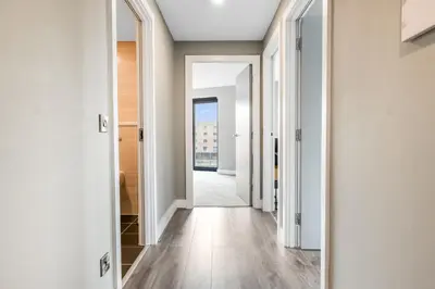 a hallway with white walls and wooden floors at Waterfront Luxury Apartment in Liverpool