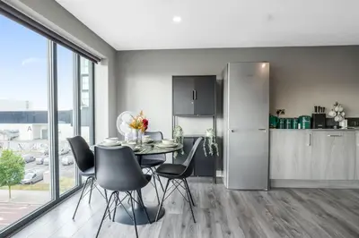 a kitchen and dining room with a table and chairs at Waterfront Luxury Apartment in Liverpool
