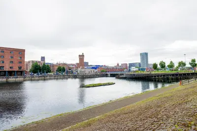 a river in a city with a bridge at Waterfront Luxury Apartment in Liverpool