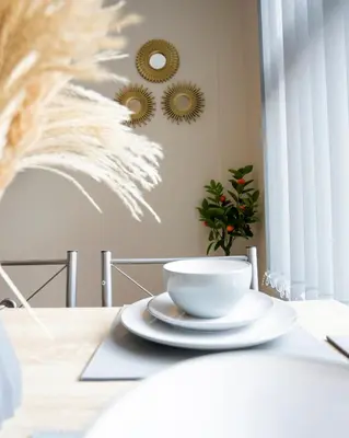 a white bowl on a table with a plate at Miles Home Anfield-Liverpool in Liverpool
